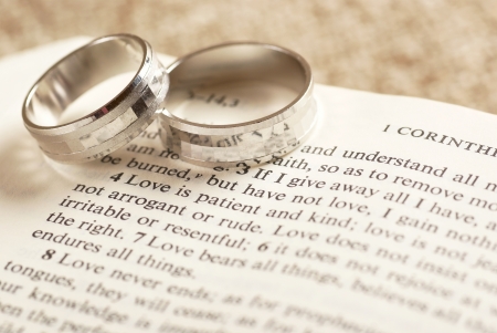 Two rings on open Bible - 1. Corinthians chapter 13.の写真素材