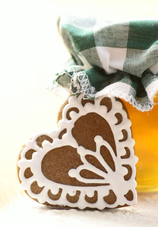 Gingerbread cookie with honey and flour on white backgroundの写真素材