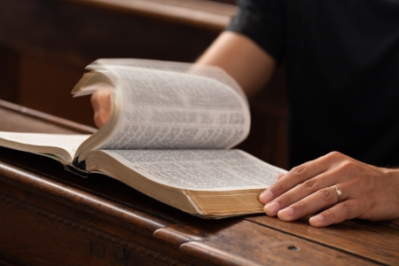 Man reading Bible in the church.の写真素材