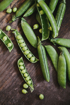 Fresh peas on a wooden table.の写真素材