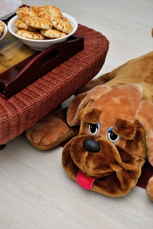 Dog-toy lying on the floor near a table with biscuitsの写真素材