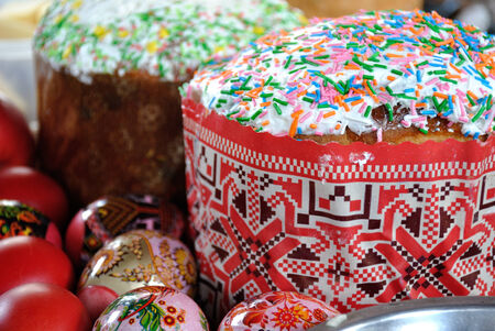 Easter pastries, traditional Easter cake covered fondant and beautiful multi-colored eggs