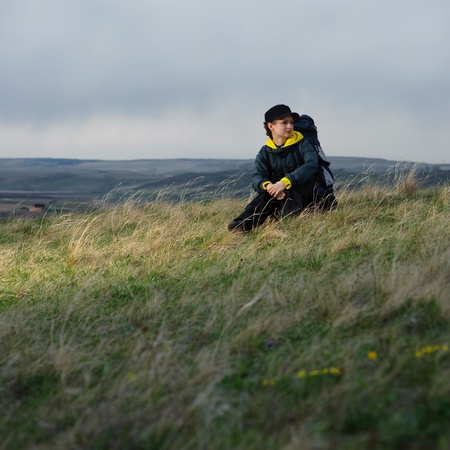 tourist with a backpack on the background of skyの写真素材