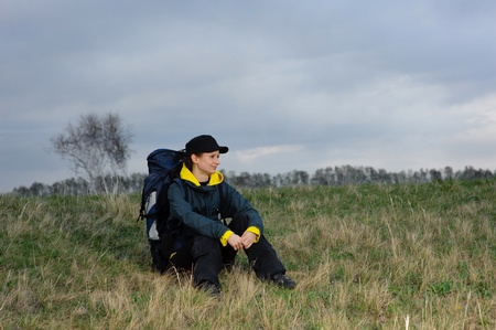 tourist with a backpack on the background of skyの写真素材