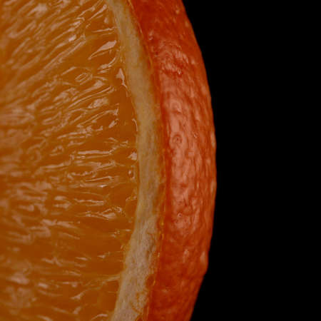 Juicy orange slice on black background close-upの写真素材