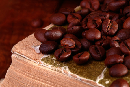 Coffee beans on old vintage bookの写真素材
