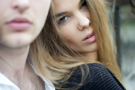 Sensual young woman looking forward with guy outdoor, horizontal pictureの写真素材