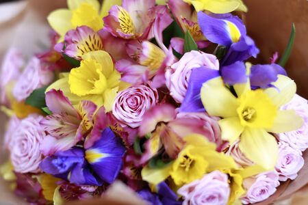 Spring bouquet of bright pink, yellow, violet and purple flowers close-up, horizontal pictureの写真素材