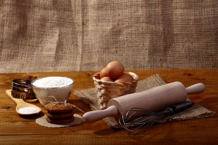 Ingredients and appliances for cooking on wooden table top on burlap backdrop coyspace, horizontal pictureの写真素材