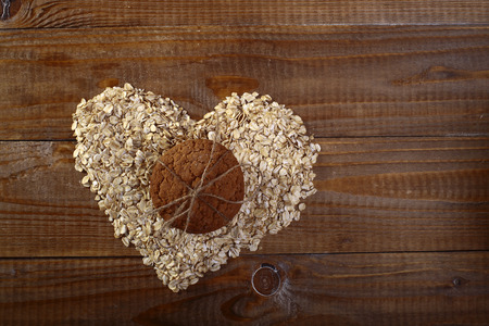 Oatcakes and heart shapes bunting on wooden table top copyspace, horizontal picture