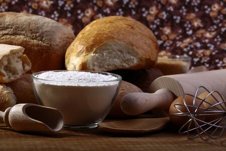 White bread flour and kitchen appliances closeup, horizontal picture