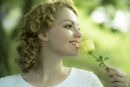 Blond woman with white rose flowerの写真素材