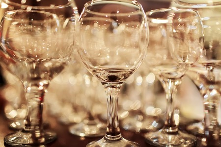 Set of clean empty wine glasses standing close to each other on table top sepia closeup, horizontal pictureの写真素材