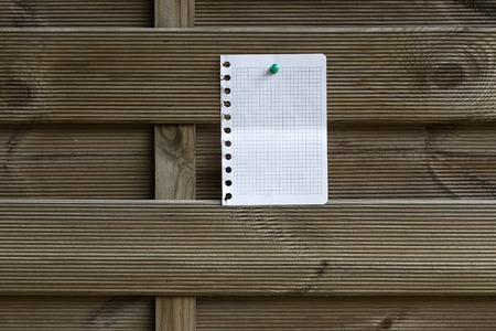Memo stick on a wooden fenceの写真素材