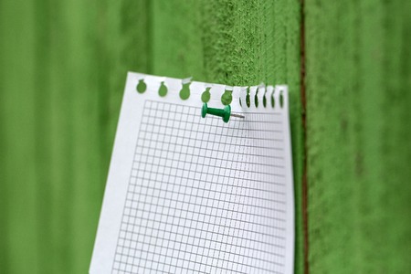 Memo stick on green wooden fenceの写真素材