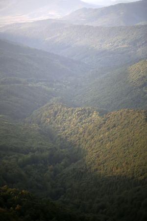 Beautiful spaciousness landscape view from high hill top on many mountain humps with deep green...