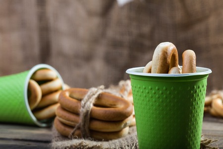 Photo closeup groups of delicious hard oval cracknels bind with string in bunches in threes and in...