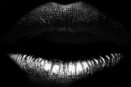 Closeup view of sexual beautiful female open closed lips isolated on studio background black and white, horizontal pictureの写真素材
