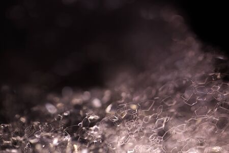 Closeup view of beautiful enigmatic mysterious white crystalline material of liquid with chemical organic foam with light as abstract natural background with no peopleの写真素材