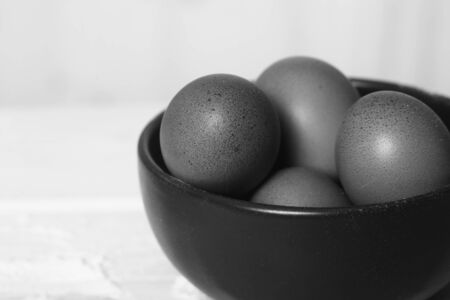 Closeup view of clay plate full of many raw whole brown chicken eggs in kitchen for preparing fresh...