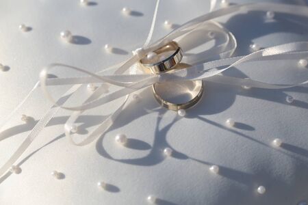 Pair of male and female shining splendid golden rings yellow gold metal for marriage day on cute...
