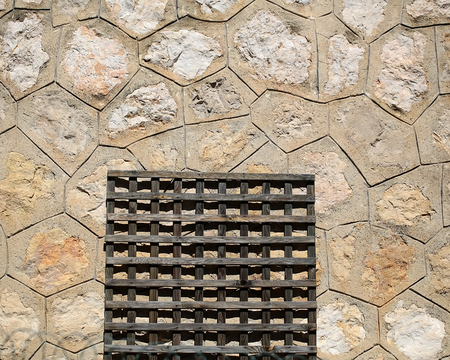 Photo closeup of unpainted timber wooden door-mat on beige cement floor tiles of various sizes and forms outdoor on concrete background, horizontal pictureの写真素材