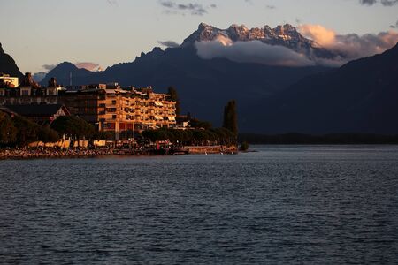 MONTREUX, SWITZERLAND - September 18, 2015: Beautiful autumn landscape of Lake Geneva with hotels on embankment of Montreux on mountains covered with clouds background at sunset, horizontal photoのeditorial素材
