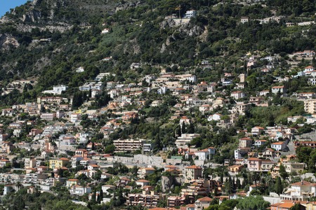 Monte Carlo, Monaco - September 20, 2015: view of mountain with densely populated city with residential buildings green trees on cityscape background, horizontal pictureのeditorial素材
