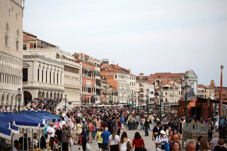 VENICE, ITALY - SEPTEMBER 22: Beautiful view of famous Saint Marko square full of crowds of tourists walking and going sightseeing on background of ancient amazing old buildings outdoor, horizontalのeditorial素材