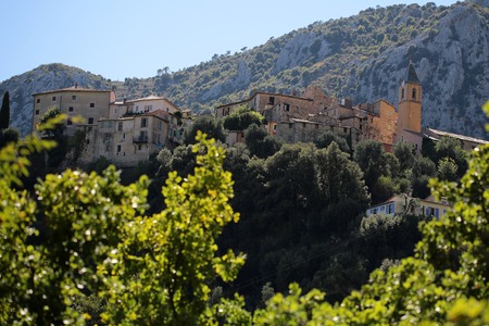 Monte Carlo, Monaco - September 20, 2015: medieval castle residential buildings green trees on mountain top against clear blue sky day time on landscape background, horizontal pictureのeditorial素材