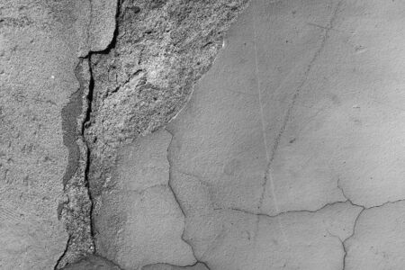 Cement wall cracked fine smooth surface premixed layer fracture grunge aged look on concrete backgroundの写真素材