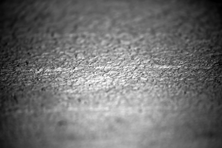 Cement wall grey coarse textured surface premixed layer with decorative effect rugged look on blurred backgroundの写真素材