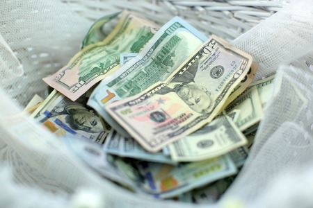 A collection of various american dollar banknotes. Many different currencies as colorful background conceptの写真素材