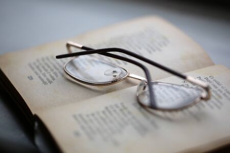 Closeup of reading glasses on the book with poems.の写真素材