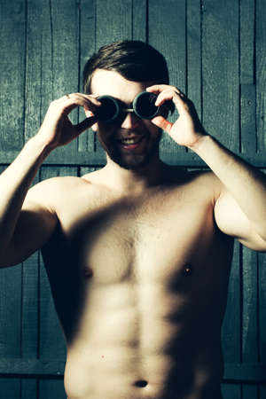 Young athletic man in swimming glassesの写真素材