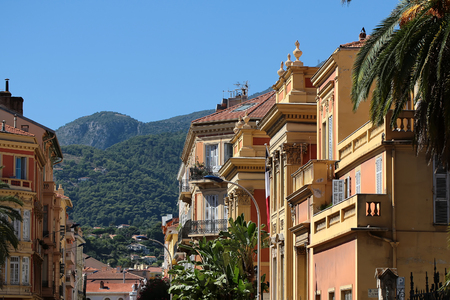 Monte Carlo, Monaco - September 21, 2015: beautiful city street with houses with terracotta plastered facade windows and balconies outdoor on mountain backgroundのeditorial素材