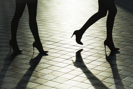 Female legs in fashionable shoes on high heels silhouetteの写真素材