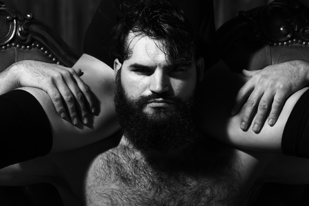 Young bearded man with female legs. Black and whiteの写真素材