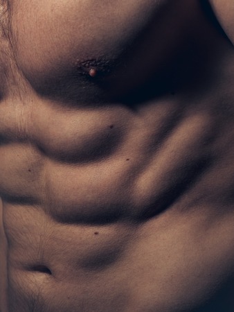Muscular torso of young man with sexy body closeupの写真素材