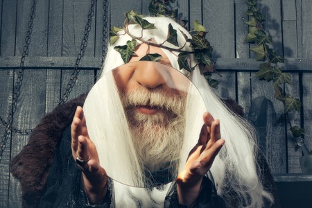 Zeus god or jupiter with magnifying glassの写真素材