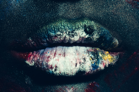 Woman with unusual paint make-up on face and lips closeupの写真素材