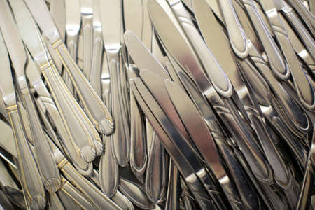 Knifes stainless steel table glossy shiny silver cutlery and utensils with different handlesの写真素材