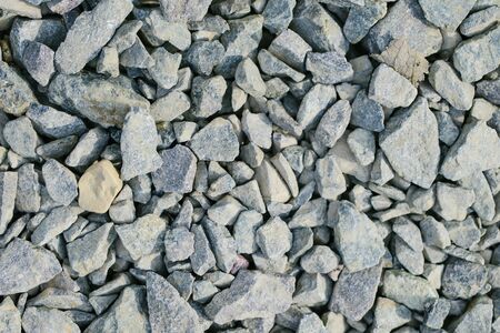background of Different grey sharp stones of all sizesの写真素材