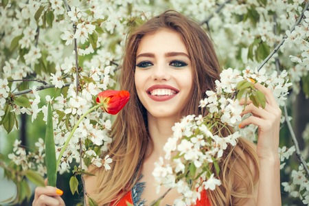 Happy girl positive energy with lovely red tulipの写真素材