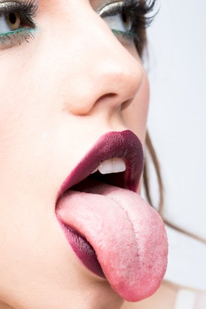 Female open mouth with sexy lips purple lipstick and tongueの写真素材