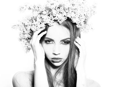 Beautiful girl model with long hair and wreath of spring lilac flowers on head black and whiteの写真素材