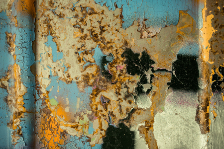 Multicolored background: rusty metal surface with paint flaking and cracking textureの写真素材
