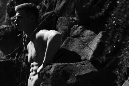 Sexy man athletic young with handsome face muscular body and bare torso pose in jeans black and...