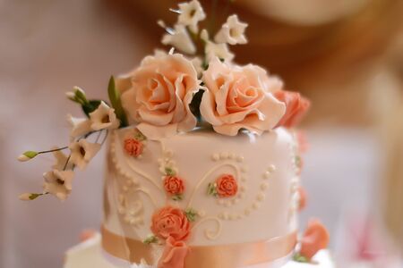 Top of tasty sweet wedding white cake dessert decorate by beautiful delicious icing sugar pink roses...