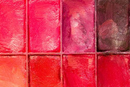 Professional makeup and lipstick palette red pink violet plum coral orange on creamy backgroundの写真素材